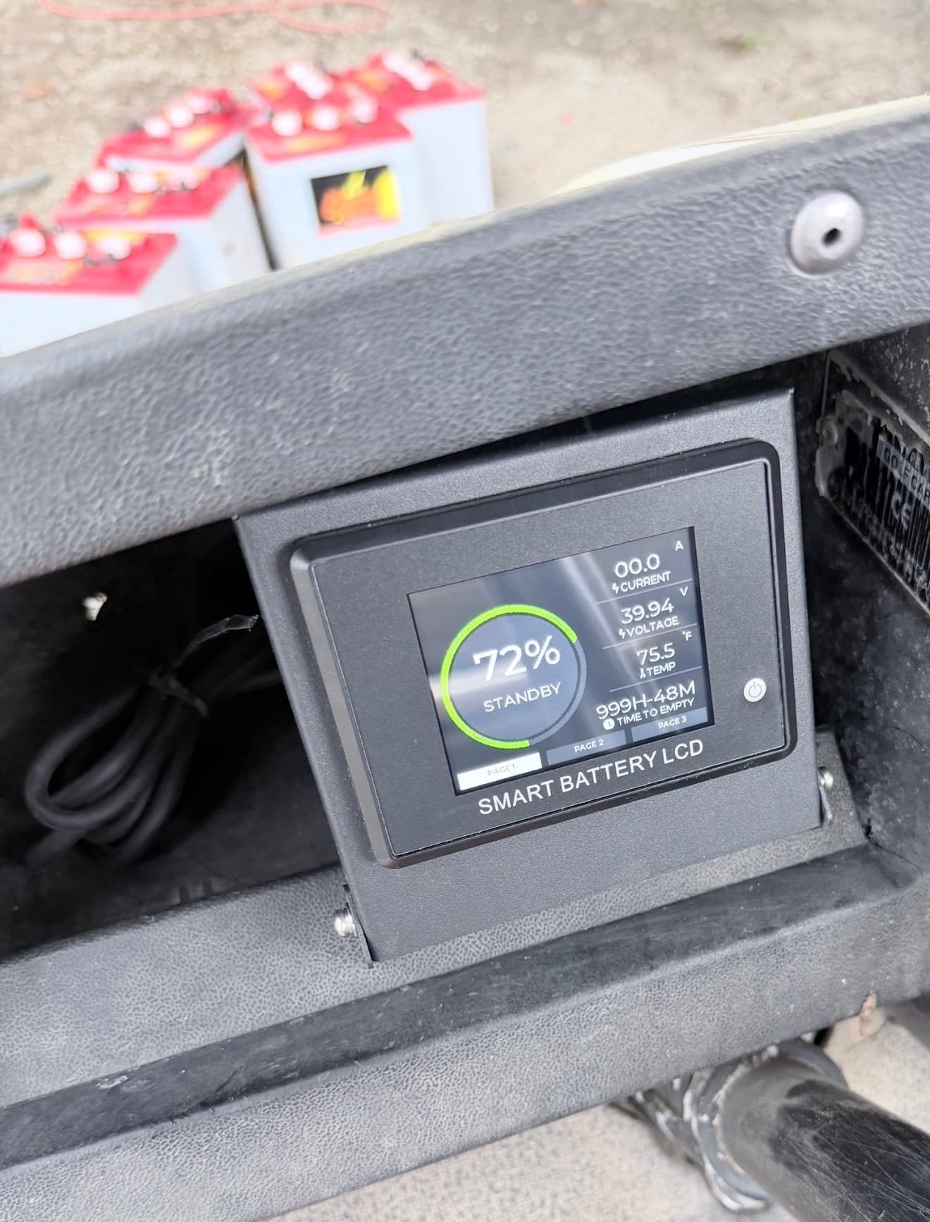 Smart battery LCD monitor installed in dash showing 72% charge